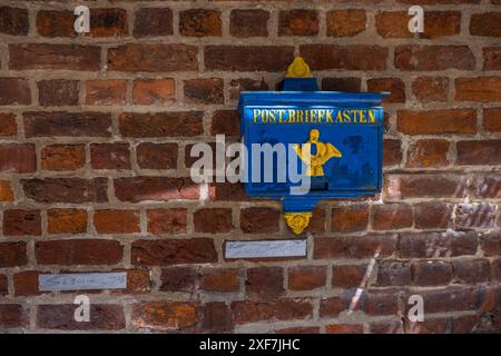 Old blue post box on a brick wall. Ansgari-Viertel, Bremen, Germany Stock Photo