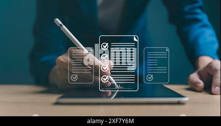 Businessman working on tablet with electronics document icons, E-document management, online documentation digital folder database, paperless office c Stock Photo
