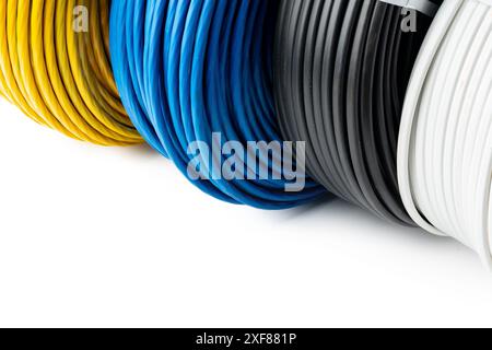 Four Spools of Electrical Wire in Yellow, Blue, Black, and White Colors: A Close-Up  Stock Photo