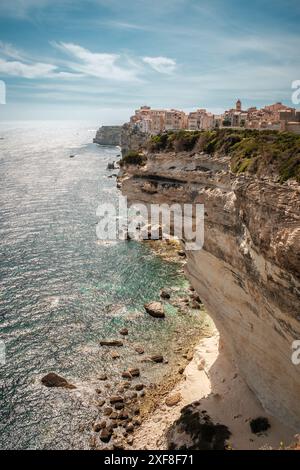 The citadel of Bonifacio in Corsica where houses are perched above the Mediterranean sea on limestone cliffs which have been undercut by the sea and w Stock Photo