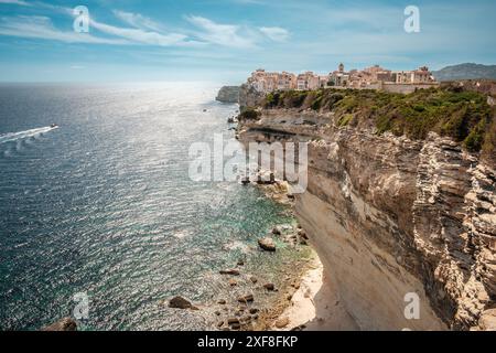 The citadel of Bonifacio in Corsica where houses are perched above the Mediterranean sea on limestone cliffs which have been undercut by the sea and w Stock Photo