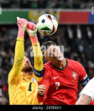 Frankfurt, Germany. 1st July, 2024. Cristiano Ronaldo (R) of Portugal vies with Slovenia's goalkeeper Jan Oblak during the UEFA Euro 2024 Round of 16 match between Portugal and Slovenia in Frankfurt, Germany on July 1, 2024. Credit: Ren Pengfei/Xinhua/Alamy Live News Stock Photo