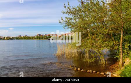 Elk, Poland - May 3, 2024: Panoramic view of Elk town with historic city center and waterfront promenade at Jezioro Elckie Lake in Mazuria lakeland Stock Photo