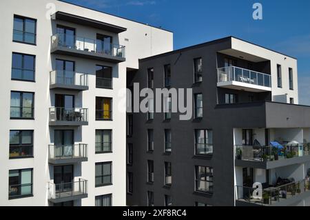 Modern residential buildings stand tall, showcasing sleek architecture and contemporary design. Apartment blocks available for purchasing. Stock Photo