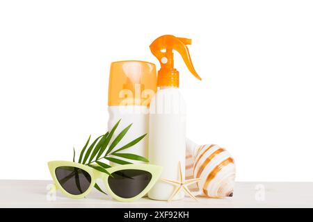 Professional Summer face skincare. Unbranded flacon with moisturizing liquid. Cream or lotion. Summer decorations, seashell and starfish, on table wit Stock Photo