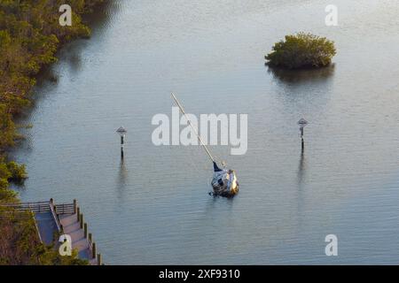 Aerial view of sunken sailboat on shallow bay waters after hurricane in Manasota, Florida. Stock Photo