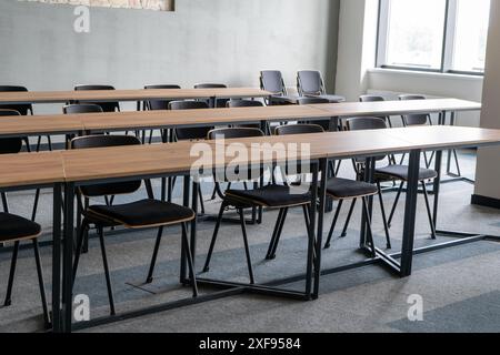 Empty room with tables and chairs for studying. University or school auditorium. Furniture in the interior. Modern style. Back to school. Study Stock Photo