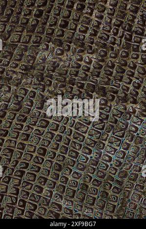 Dark abstract pattern with a textured, geometric design featuring intricate squares Stock Photo