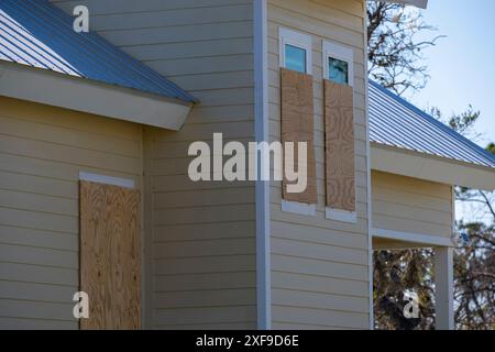 Plywood storm shutters for hurricane protection of house windows. Protective measures before natural disaster in Florida Stock Photo