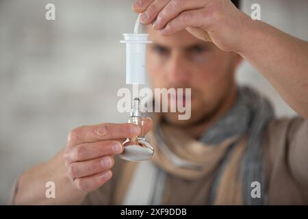 electrical engineer installing ceiling lamps in the hallway Stock Photo