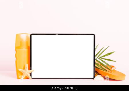 Flat lay composition with tablet and beach accessories on colored background. Tablet computer with blank screen mock up with copy space. Stock Photo
