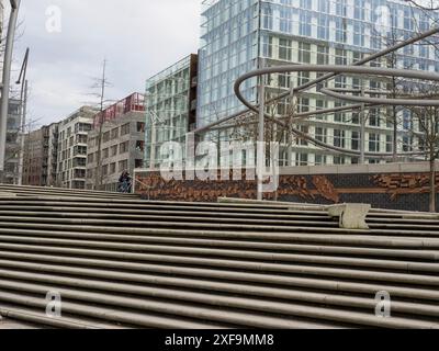 Modern buildings with large glass facades and stairs in an urban environment under a cloudy sky, hamburg, germany Stock Photo