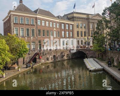 City view with historic buildings and bridge over a river, boats on the shore, under a clear sky, utrecht, netherlands Stock Photo