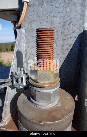 one big old brown red rusty bolt with nuts and washers Stock Photo