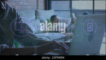 Image of connected icons, connected dots over midsection of african american man using laptop Stock Photo