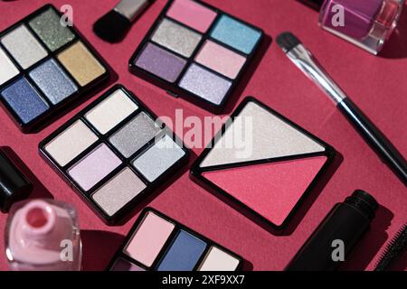 Makeup set - eye shadow, nail polishes and more on a pink background Stock Photo