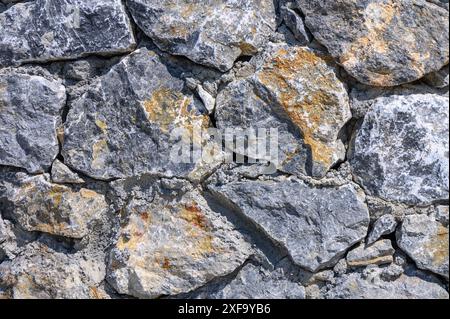 fence made of beautiful gray wild stone as a background 1 Stock Photo