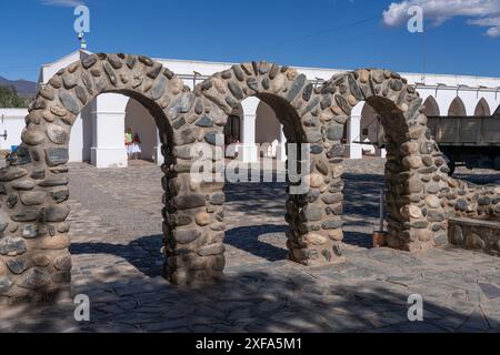 Stonework arches on the Plaza 9 de julio, the town square in Cachi, Argentina.  Behind are the arches of the Pio Pablo Diaz Arqueological Museum. Stock Photo