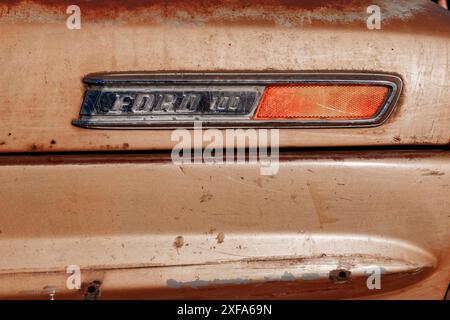 closeup detail of vintage american Ford 100 badge logo and indicator side repeater Stock Photo