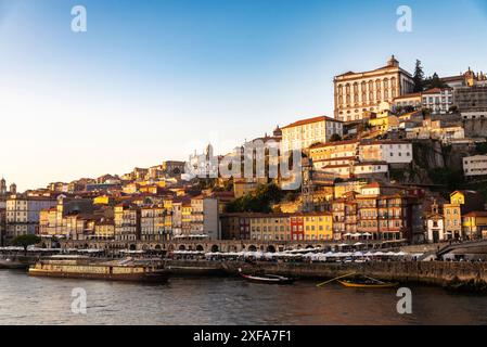 Oporto, Portugal - November 24, 2023: View of the The Ribeira area along the Douro river at sunset in Oporto or Porto, Portugal Stock Photo