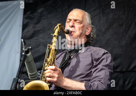 Guildford / UK - Jun 29 2024: Saxophonist Davy Payne performing with The Blockheads on day one of Guilfest music festival, Guildford, Surrey, UK. Stock Photo