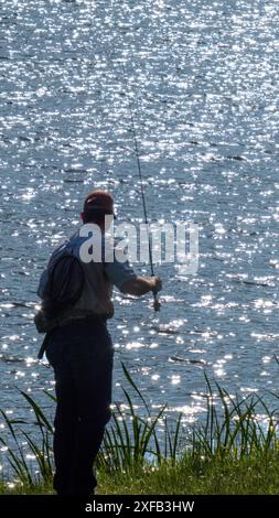 Single man fishing at Abbott Lake near Peaks of the Otter lodge, Blue Ridge Parkway, Virginia. Stock Photo