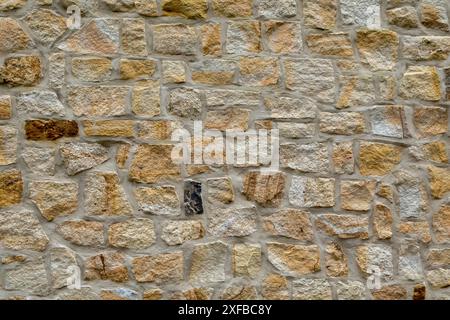 Natural stone wall with a mixture of beige and grey bricks, sandstone wall, background, texture, North Rhine-Westphalia, Germany Stock Photo