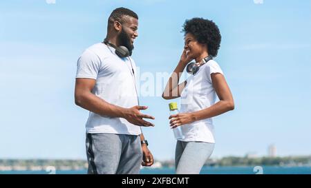 Man And Woman Talking After Morning Jog Near River Stock Photo