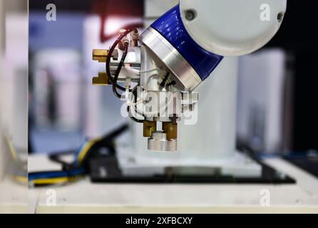The process of producing automotive parts to be transported by a robot arm with industrial automation. Stock Photo