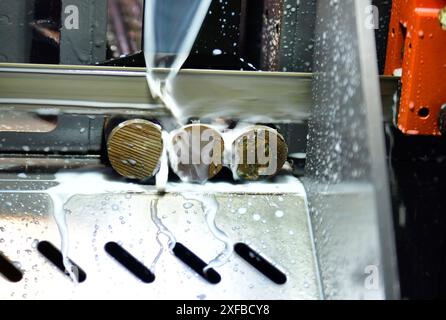 Industrial metal working cutting process The raw material bar clamping on the CNC lathe machine Stock Photo
