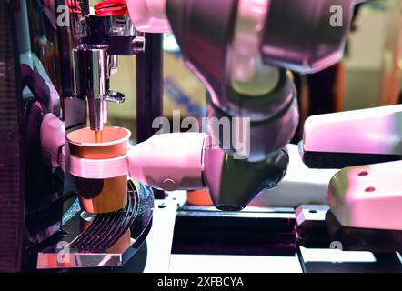 Automatic technology in beverage shop, artificial intelligence, robotic arm serving in coffee shop. Stock Photo