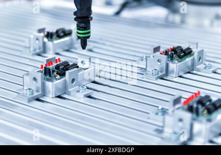 Automatic screwdriving technology on the electronic circuit board in the factory production line Stock Photo
