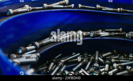 Many small Screw nuts by manufacturing process in factory Stock Photo