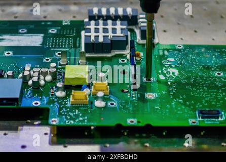 Automatic screwdriving technology on the electronic circuit board in the factory production line Stock Photo