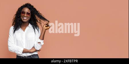 Woman With Long Curly Hair Wearing Sunglasses and White Shirt Stock Photo