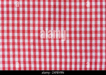 A red and white checkered fabric. The checkered pattern is very repetitive and bold, the colors are bright. Stock Photo