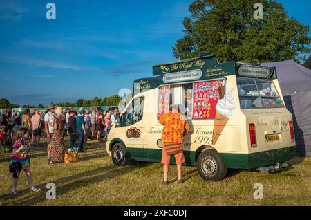 Guildford / UK - Jun 29 2024: A man buys an ice cream at an ice cream van at Guilfest music festival, Guildford, Surrey, UK. Stock Photo