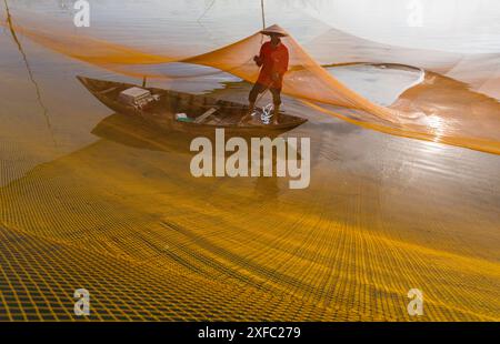 Local fisherman catching fish at dawn on the Thu Bon River in Cua Dai fishing village near Hoi An, Central Vietnam, Asia in June Stock Photo