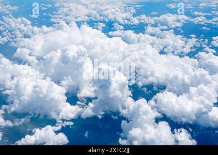 Landscape of beautiful fluffy puffy white cumulus clouds on blue sky background, top view, clear blue sky and white clouds, scenic cloudy weather Stock Photo