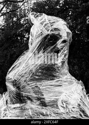 Creepy Face, Wrapped in Nylon. Halloween Theme , concept. Black and white, monochrome detail. Stock Photo