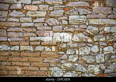 Full frame of  ancient brickwork made with bricks and stone blocks of different shapes, sizes, and colors, Umbria, Italy Stock Photo
