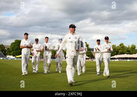 Cheltenham, UK, 2 July 2024. Gloucestershire's James Bracey leads the team off the field after scoring a double century earlier in the day during the Vitality County Championship Division Two match between Gloucestershire and Glamorgan. Credit: Robbie Stephenson/Gloucestershire Cricket/Alamy Live News Stock Photo