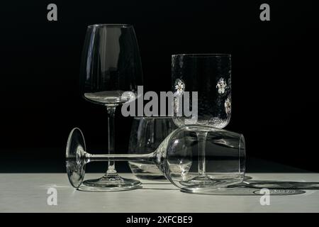 Assorted glassware for various drinks in sunlight. Stock Photo