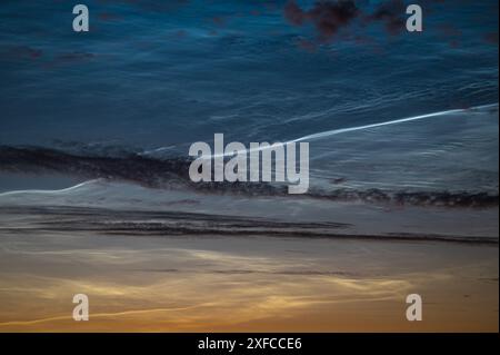 Zoomed-in view of noctilucent clouds (NLC) with an exceptionally bright waving band Stock Photo