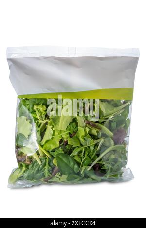 Mix of cut and washed ready-to-eat salad in plastic bag for supermarket sale, isolated on white with clipping path included Stock Photo