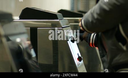 Turnstile to the metro station. People use the token to pay for their fare. Stock Photo