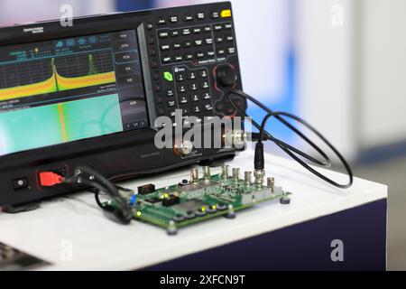 Printed circuit board testing by the spectrum analyzer in the telecommunication laboratory. Selective focus. Stock Photo