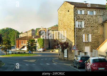 Langeac, France - May 27, 2023: A peaceful roundabout in Langeac, France, with stone buildings and lush greenery. Stock Photo