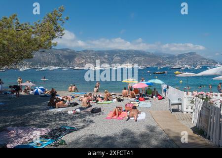 The secluded beach of La Paloma, St-Jean-Cap-Ferrat, on the French Riviera, with a beautiful view of many luxury mega yachts on the Mediterranean sea Stock Photo