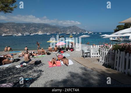 The secluded beach of La Paloma, St-Jean-Cap-Ferrat, on the French Riviera, with a beautiful view of many luxury mega yachts on the Mediterranean sea Stock Photo